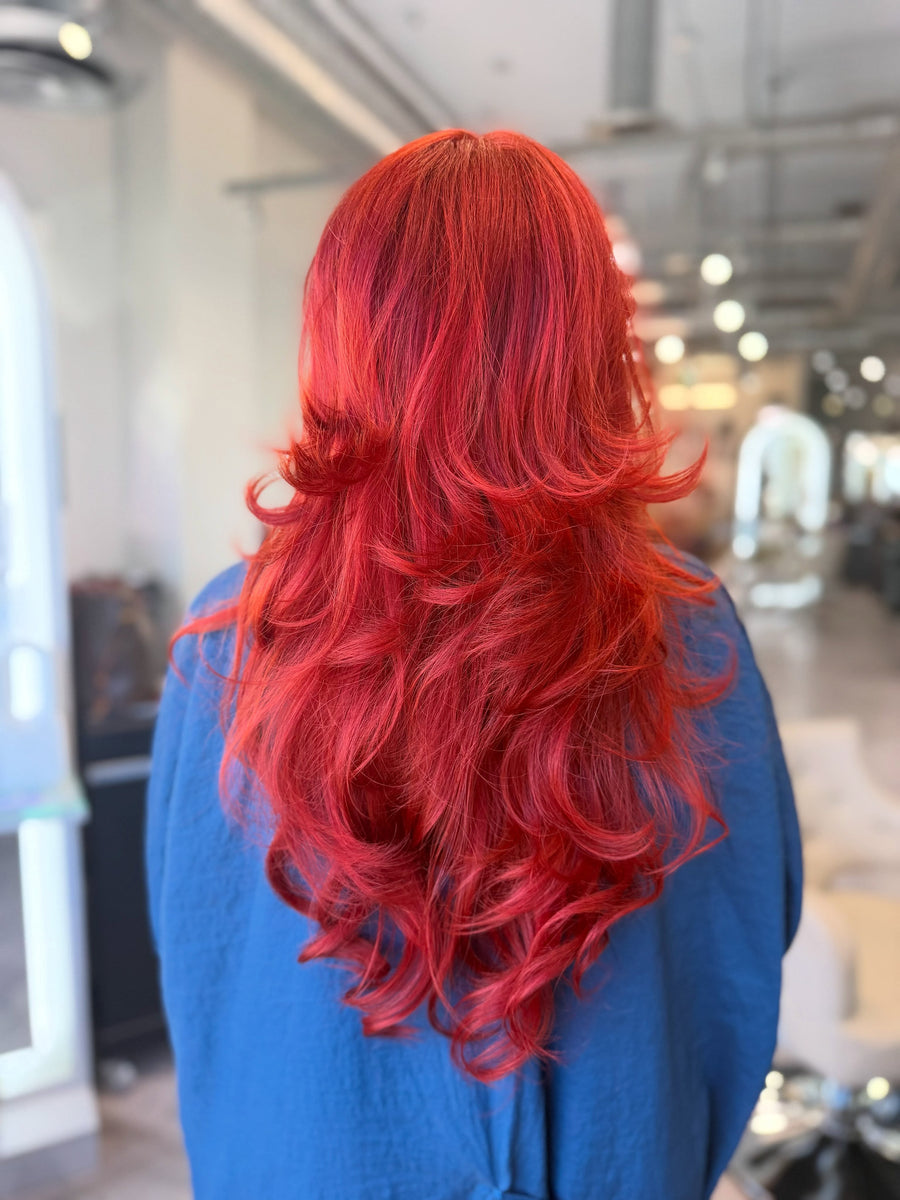 Vivid red color with long layers by Sam at Salon Sora, Boca Raton
